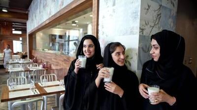 Recent Zayed University Public Relations and Advertising graduates, (L-R) Fatima Al Nokhatha, Hessa Al Mulla and Mariam Al Zahabi pose for a portrait with a glass of milk on a Sunday evening, July 10, 2011, at Social Hub restaurant in Abu Dhabi. During their last semester, the young women worked on a project with the Abu Dhabi Food Control Authority on an awareness campaign about the importance of eating and drinking dairy products.