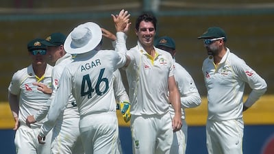 Australia's captain Pat Cummins celebrates with teammates dismissing Pakistan's Fawad Alam. AFP