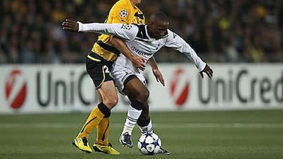 Jermain Defoe, right, of Tottenham shields the ball from Xavier Hochstrasser on the artificial turf of the Stade de Suisse last night.