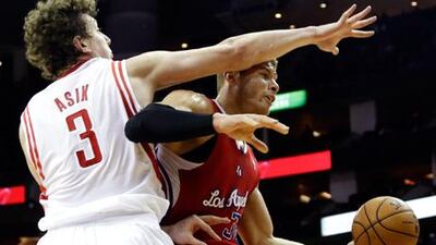Los Angeles Clippers' Blake Griffin is fouled by Omer Asik of the Houston Rockets.