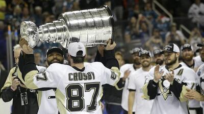 8. Pittsburgh Penguins centre Sidney Crosby, No 87, hands the Stanley Cup to defenceman Trevor Daley after Game 6 of the Stanley Cup Finals against the San Jose Sharks in San Jose The Penguins won 3-1 to win the series 4-2. Marcio Jose Sanchez / AP Photo