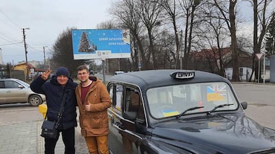 Mr Tymchyshyn with one of his passengers. PA