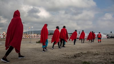 Migrants disembark from the deck of the Spanish NGO Proactiva Open Arms rescue vessel. AP