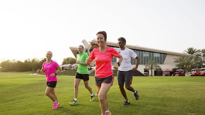 Left to right, ultra runners Ruanda Oberholzer, Chris Denison, Veronique Bourbeau and Khalid Hamid train at Abu Dhabi Golf Club. The athletes run distances of 50km and more. Christopher Pike / The National