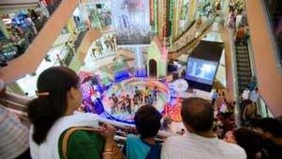 Shoppers look on during a promotional event inside the Inorbit Mall Malad shopping center in Mumbai, India.