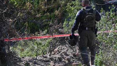 A crater is cordoned off after a projectile landed in Bareket, east of Tel Aviv, Israel. Getty Images