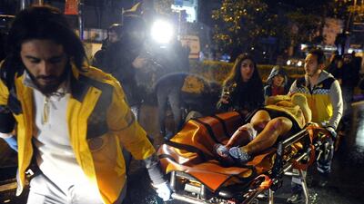 Medics carry a person wounded in the Istanbul nightclub attack on New Year's Day, 2017. IHA via AP