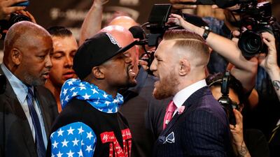 Floyd Mayweather and mixed martial arts champion Conor McGregor square off during a promotional tour for their fight next month