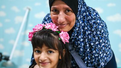 Lama Mady with her mother Sabine after being checked by doctors at Emirates Humanitarian City in Abu Dhabi