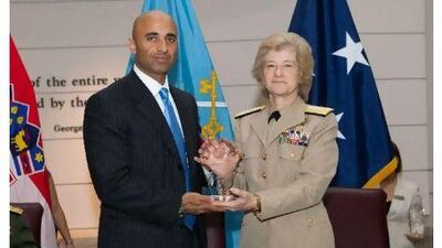 Yousef al Otaiba was honoured at a ceremony on Thursday. At right is Vice Adm Ann E Rondeau, president of the National Defence University. WAM