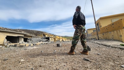 A soldier surveys the scene after drones struck an arms depot at an Iranian-Kurdish opposition group’s base in Dekala, Iraqi Kurdistan. Reuters