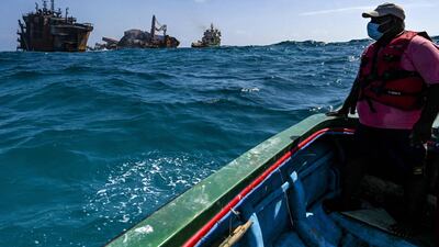 The Singapore-registered ship is carrying hundreds of containers of chemicals and plastics. AFP