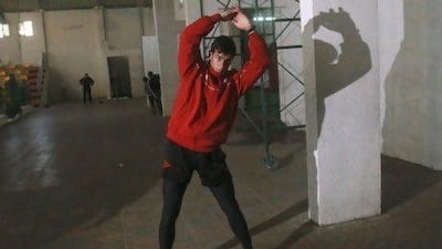 Bahaa Al Farra, above, will compete in the 400-metre Olympic race, trains at a gym in Gaza City, but next month he will go to Qatar to finish his preparations ahead of the Summer Games.