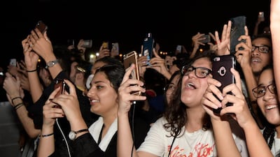 Fans film and wave during the Jeddah World Fest. AP Photo