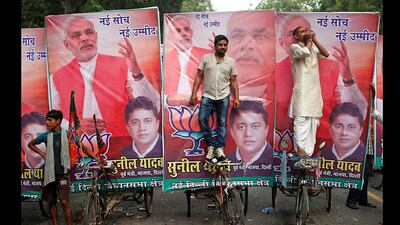 A supporter (R) blows a conch shell during celebrations before India's Hindu nationalist Narendra Modi was crowned as the prime ministerial candidate for India's main opposition Bharatiya Janata Party (BJP) outside the party headquarters in New Delhi. Ahmad Masood / Reuters