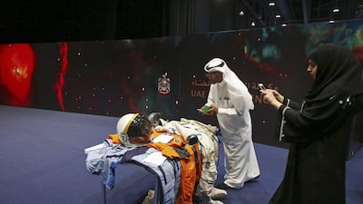 Emirati visitors take photos at the Space Museum during the launch of the UAE Space Agency strategic plan. Kamran Jebreili / AP Photo