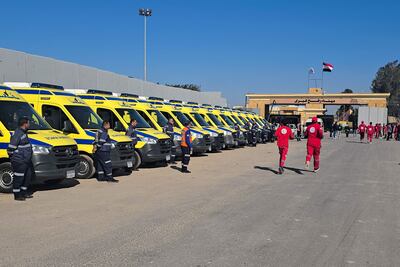 Paramedics and ambulances waiting on the Egyptian side of the Rafah border crossing with the Gaza Strip on Saturday. AFP