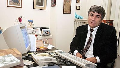Hrant Dink, an ethnic Armenian Turkish journalist, poses at his office in Istanbul in October 2005. He sparked fury among Turkish nationalists after writing an article calling the killing of Armenians under the Ottoman Empire genocide. He was assassinated in January 2007.