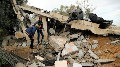 Palestinians inspect the site of an Israeli air strike in Khan Younis. Reuters