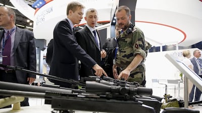 Military men look at riffles made by Russian manufacturer KBP on display at the Eurosatory international Land and Air-Land Defense and Security fair in Paris. Yoan Valat / EPA