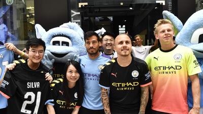 David Silva, Angelino and Oleksandr Zinchenko take pictures with fans during a promotional event in Hong Kong. Reuters