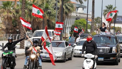 Anti-government demonstrators wave Lebanese flags as they protest in their cars, amid a countrywide lockdown to combat the spread of the coronavirus disease in Beirut, Lebanon. Reuters