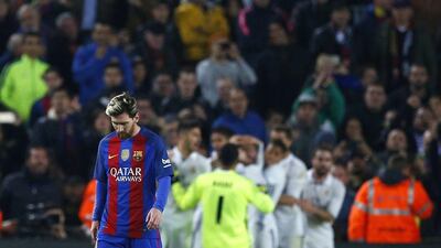 Barcelona's Lionel Messi looks down as Real Madrid players celebrate on Saturday. Francisco Seco / AP Photo / December 3, 2016