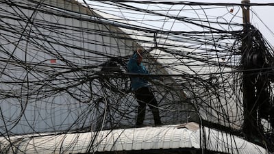 An electrician untangles electrical wires along a street in Phnom Penh, Cambodia. Samrang Pring / Reuters
