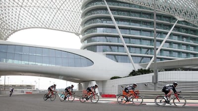 Team UAE-Abu Dhabi riders pass the Yas Viceroy Hotel next to the Yas Marina Circuit.