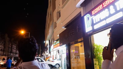 Residents of Doha watch as Qatar's air defences intercept missiles launched by Iran on Monday. AFP