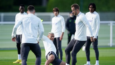 Tottenham's Harry Kane, right, and Richarlison battle for the ball during a training session. PA