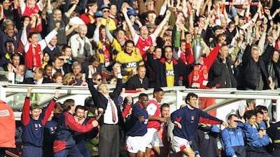 Manager Arsene Wenger and the Arsenal bench celebrate winning the Premier League after beating Everton 4-0 at Highbury on May 3, 1998. Getty