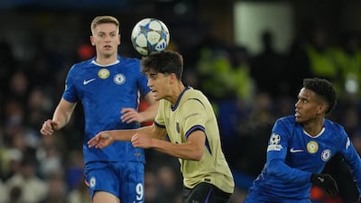 Barcelona's Pau Cubarsi, centre, heads the ball past Chelsea's Estevao, right, and Liam Delap. AP