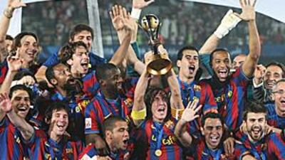 Carlos Puyol lifts the Club World Cup with his Barca teammates.