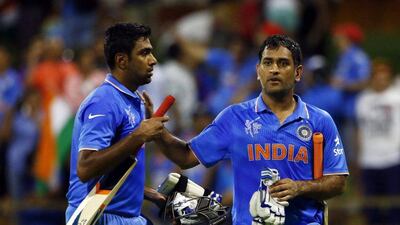 Ravichandran Ashwin, left, and MS Dhoni walk off the field together following their four wicket victory against the West Indies at the Cricket World Cup in Perth. David Gray / Reuters
