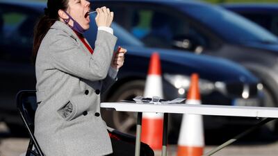 A woman gives a swab sample at a testing centre in Liverpool. Reuters