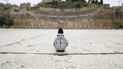 A watch showing the time at noon, is displayed for a photo in front of the Roman amphitheatre, which is empty during the coronavirus disease outbreak, in Amman, Jordan. Reuters