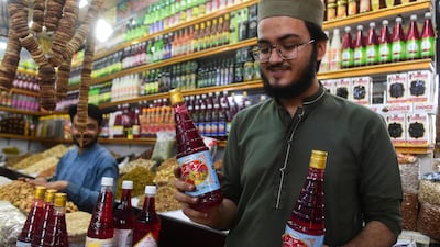 Rooh Afza on sale at a market in Karachi. The popular iftar drink contains 414 calories per 100ml serving. AFP