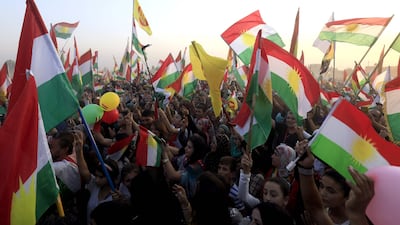Syrian Kurds take part in a rally in the Syrian city of Qamishli in support of the independence referendum on September 25. Delil Souleiman / AFP