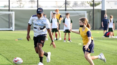 Former Fiji captain Osea Kolinisau and his Speranza 22 teammates lead a training session for young rugby players at Royal Grammar School Guildford Dubai, ahead of the Dubai Sevens tournament. All images: Pawan Singh / The National