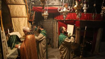 Priests say Mass at the Holy Cave in the Church of Nativity in Bethlehem. EPA