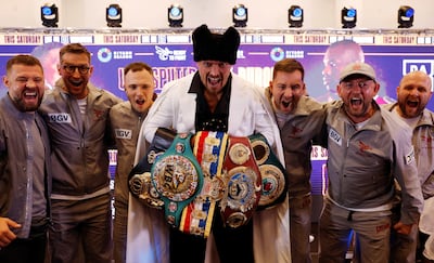 Oleksandr Usyk poses with his belts. Reuters