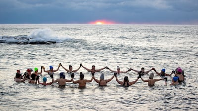 A group, mostly women, who call themselves The Endorphins, take a sunrise swim in the chilly waters of Lake Ontario despite freezing temperatures in Toronto, Canada. Reuters