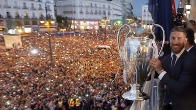Real Madrid captain Sergio Ramos holds the Uefa Champions League trophy in front of thousands of Real Madrid fans at the balcony of the Madrid Autonomous Government's headquarters. JJ Guillen / EPA
