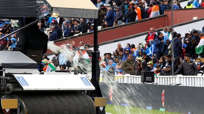 They had to pour excess water off the field as rain continued to delay the start of the game. Sang Tan / AP Photo