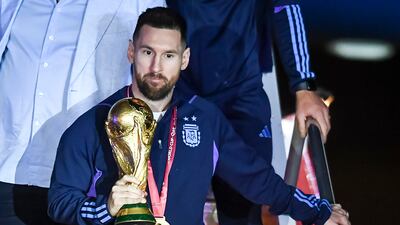 Argentina captain Lionel Messi with the World Cup trophy after arriving at Ezeiza International Airport. Getty