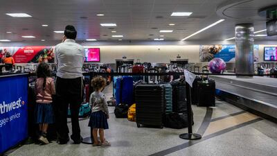 A family waits for their luggage on Wednesday in Houston, Texas. AFP