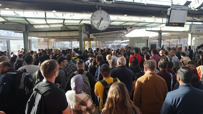 Passengers wait for Stratford station to open in London on Wednesday morning as train services continue to be disrupted following the nationwide strike by members of the Rail, Maritime and Transport union. PA