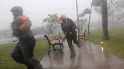 Members of the civil defense in Fajardo, Peurto Rico, run as Hurricane Irma howls past Puerto Rico after thrashing several smaller Caribbean islands. Alvin Baez / Reuters / September 6, 2017.