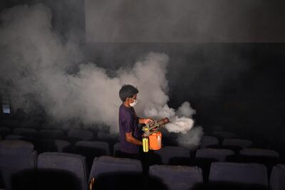 A worker fumigates a closed multiplex cinema to prevent the spread of the Covid-19 coronavirus in Ahmedabad. AFP